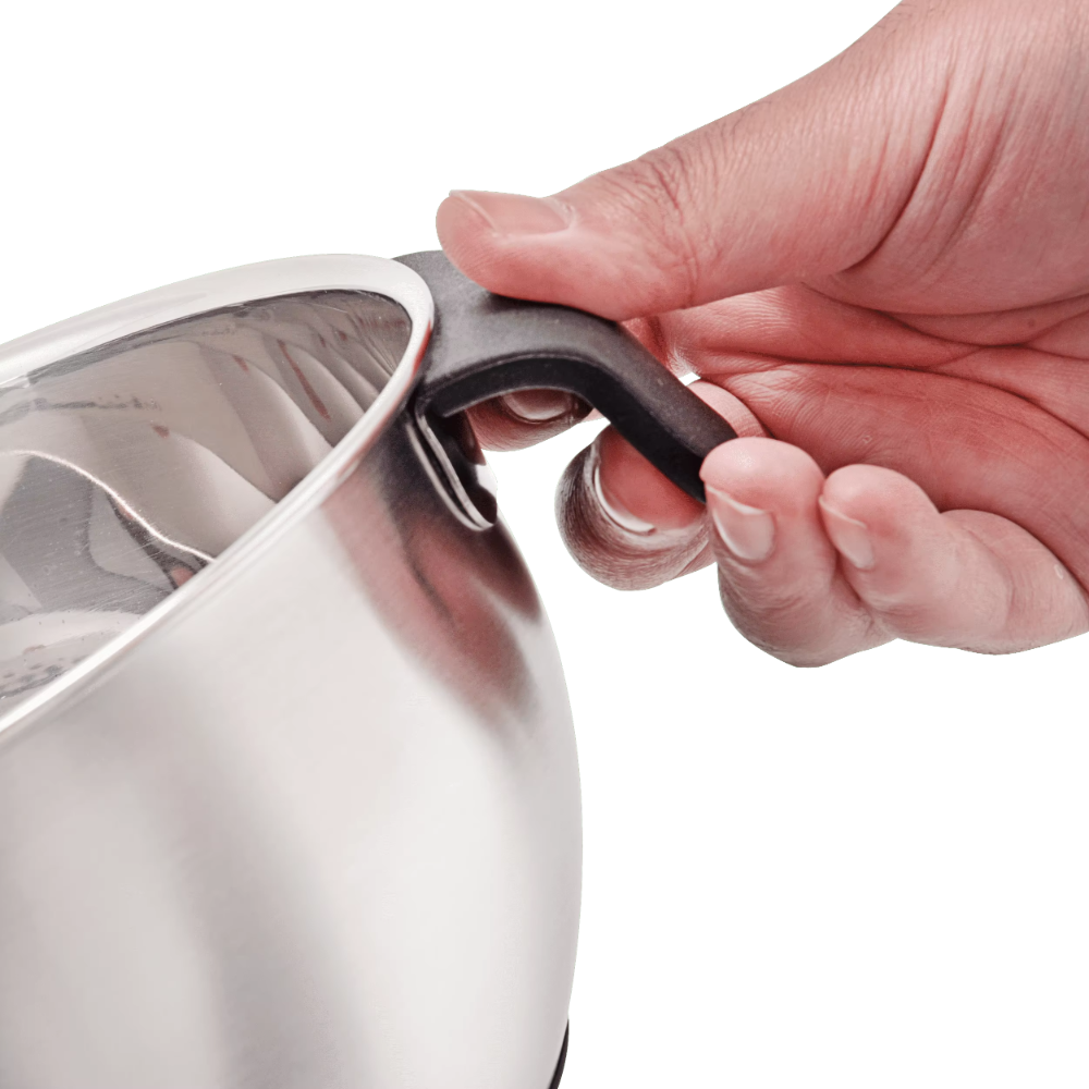Hand holding a black handle on a silver pot against a white background